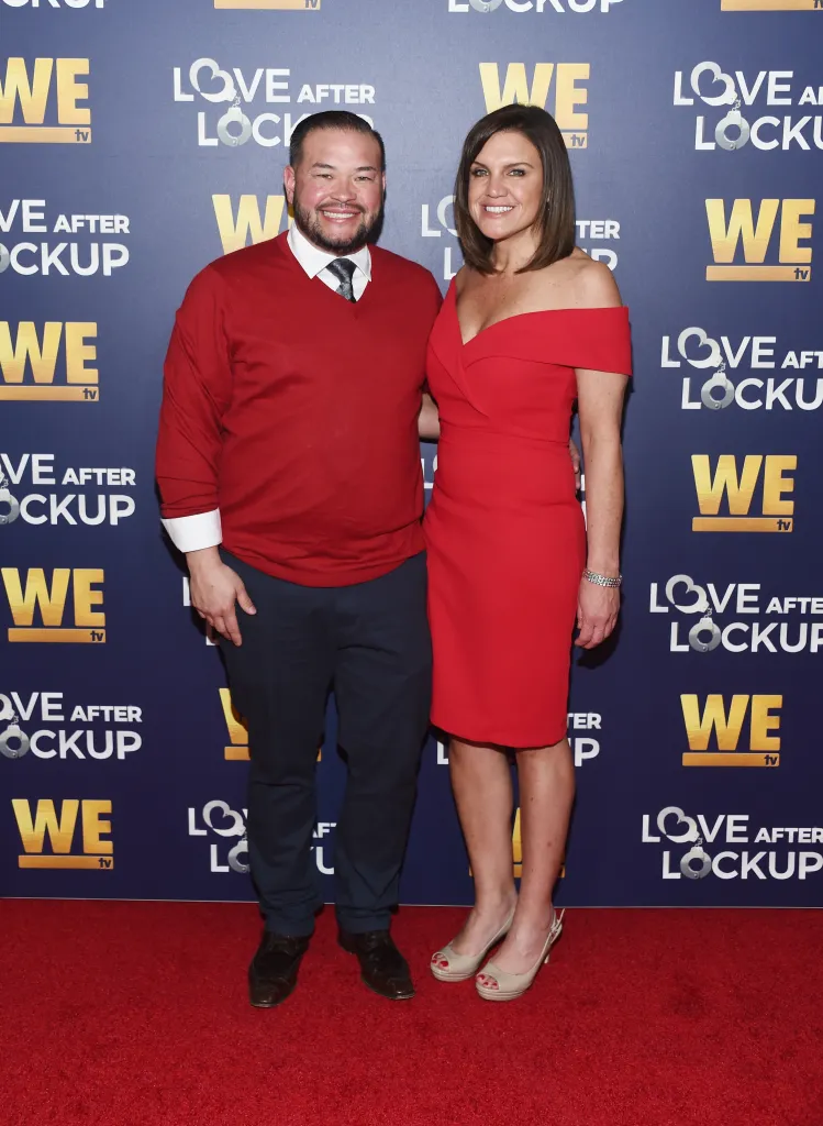 Jon Gosselin and Colleen Conrad pose together on a red carpet in front of a branded backdrop.