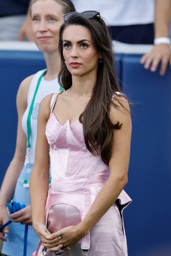 Jordon Hudson looking on from the sideline during a football game.
