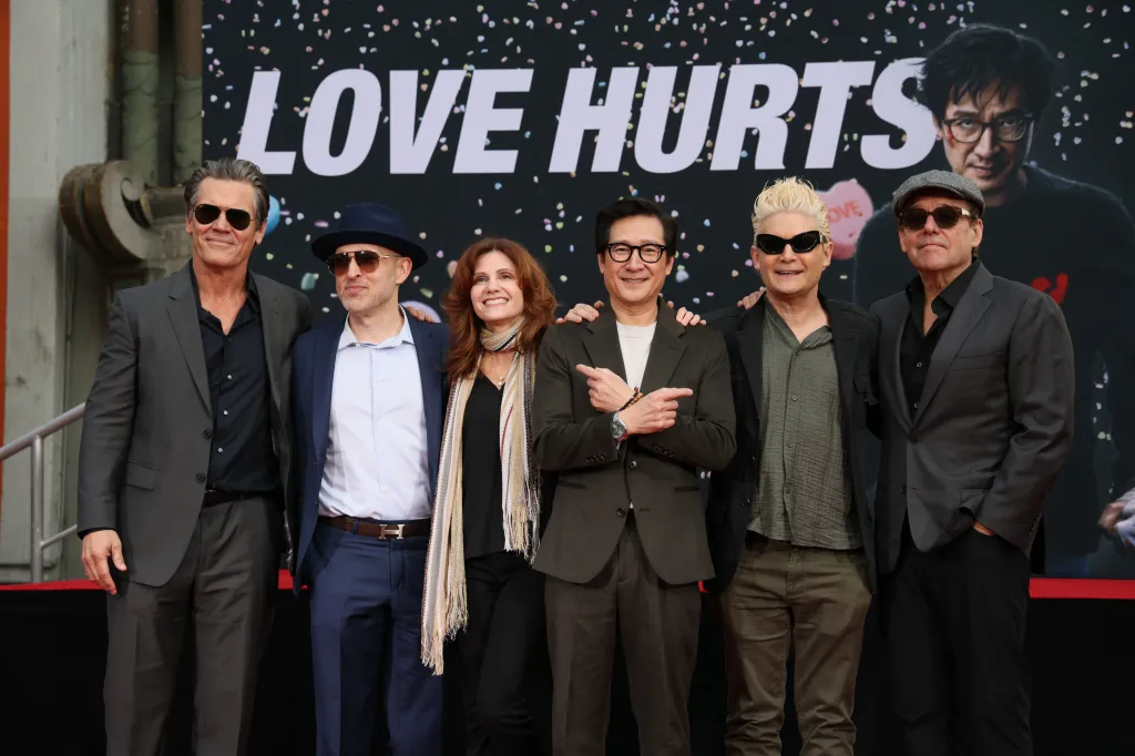 Josh Brolin, Jeff Cohen, Kerri Green, Ke Huy Quan, Corey Feldman and Chris Columbus pose in front of a