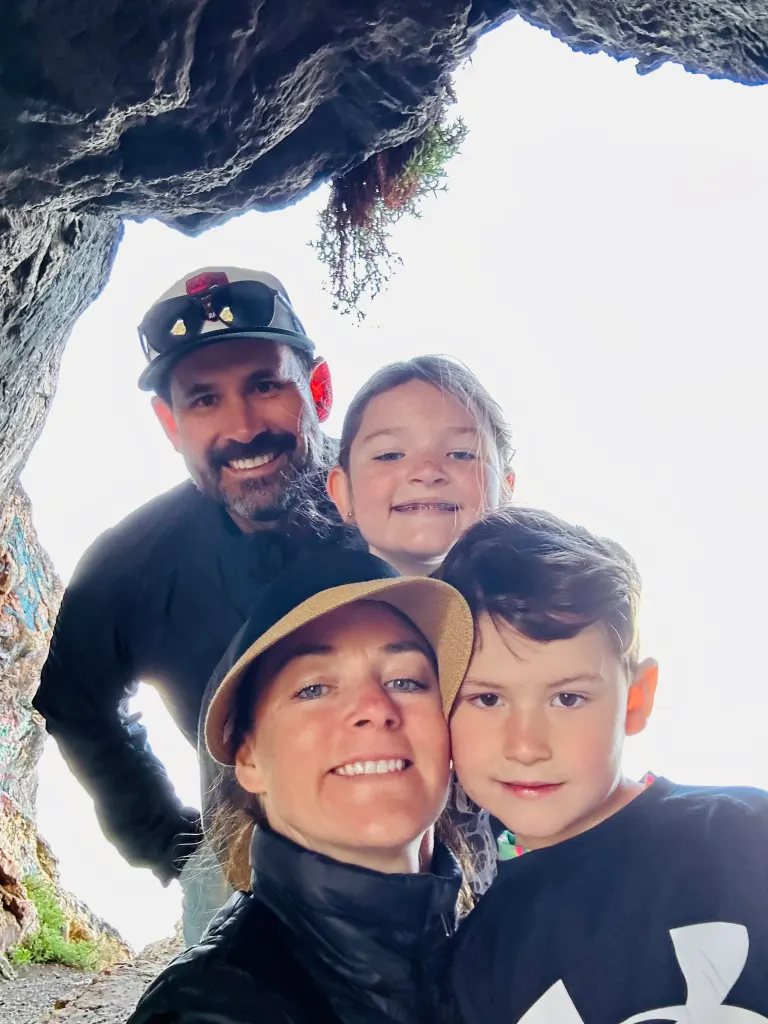 Justin Derby and his family pose together outdoors.