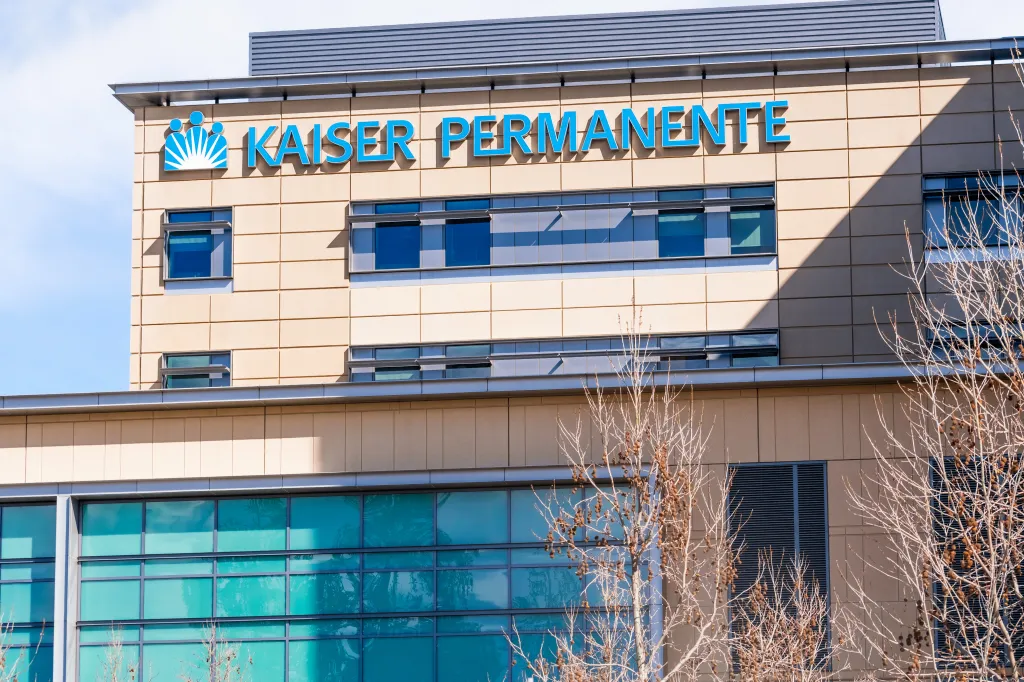 Exterior view of the Kaiser Permanente Hospital building with blue lettering and logo.