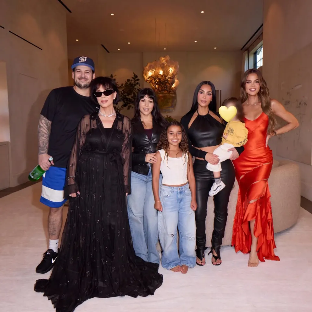 The Kardashian family posing together indoors.
