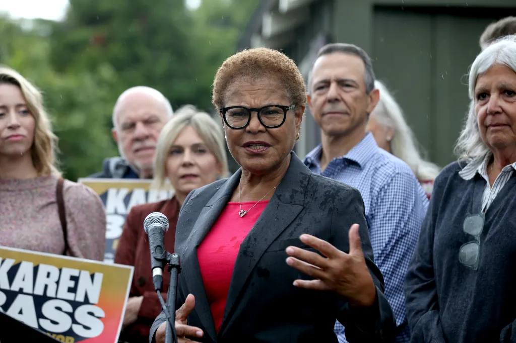 Karen Bass speaks to the media during a campaign stop, surrounded by supporters.