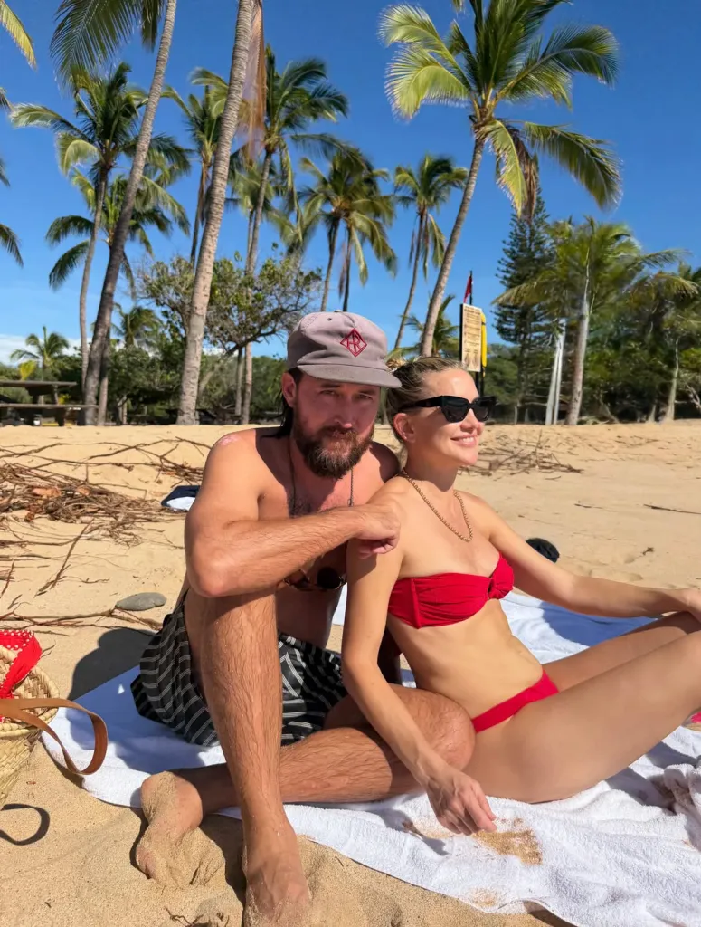 Kate Hudson and her fiancé on a beach.