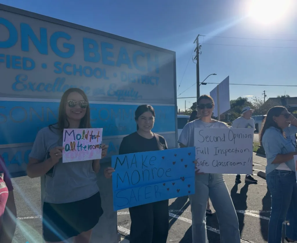 Parents holding signs protesting outside the Long Beach Unified School District.