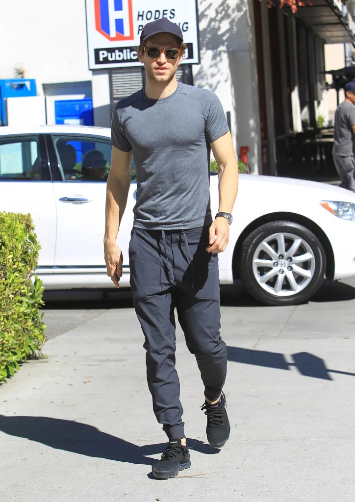 Keegan Allen walking on a sidewalk in Los Angeles.