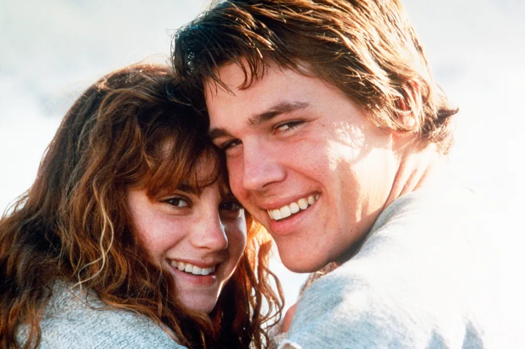 Kerri Green and Josh Brolin smiling in a scene from The Goonies.