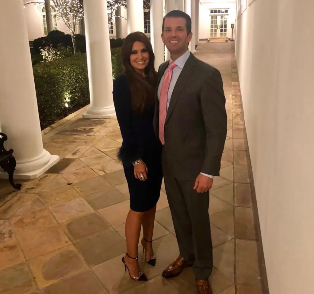 Kimberly Guilfoyle and Donald Trump Jr. standing outside on a patio.