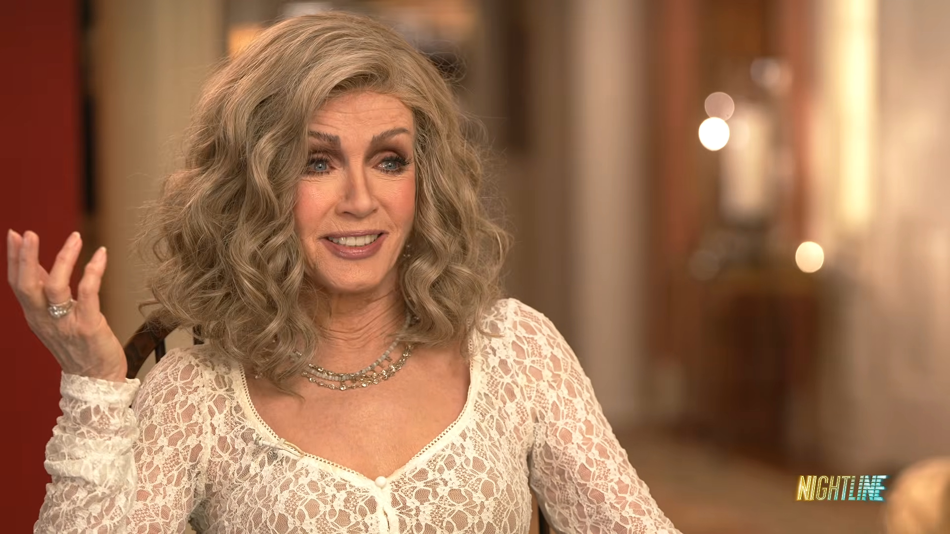 Donna Mills sitting in an interview setting.