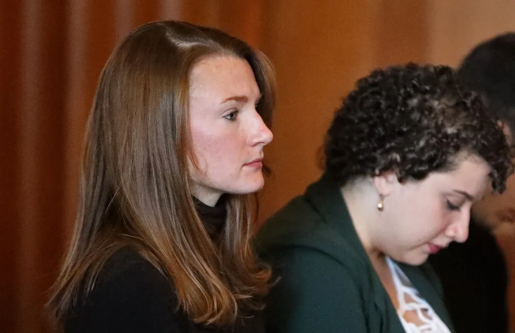 Kristin Knouse, left, sits behind the bar with Lexi Foman during a motions hearing.
