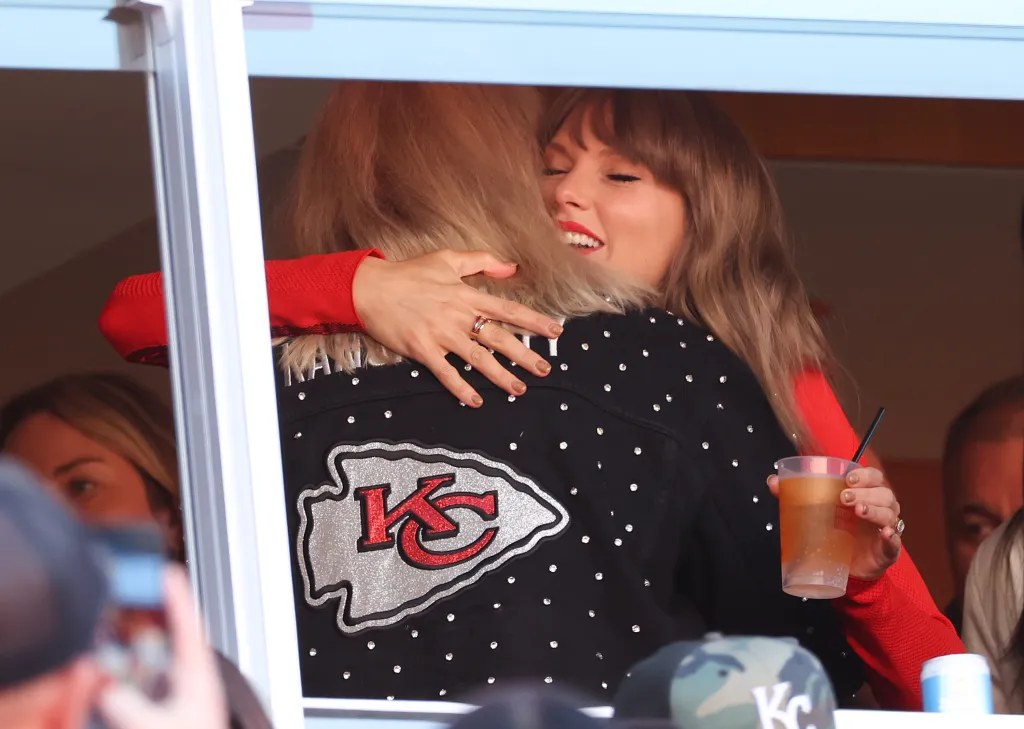 Donna Kelce hugs Taylor Swift in a stadium suite.