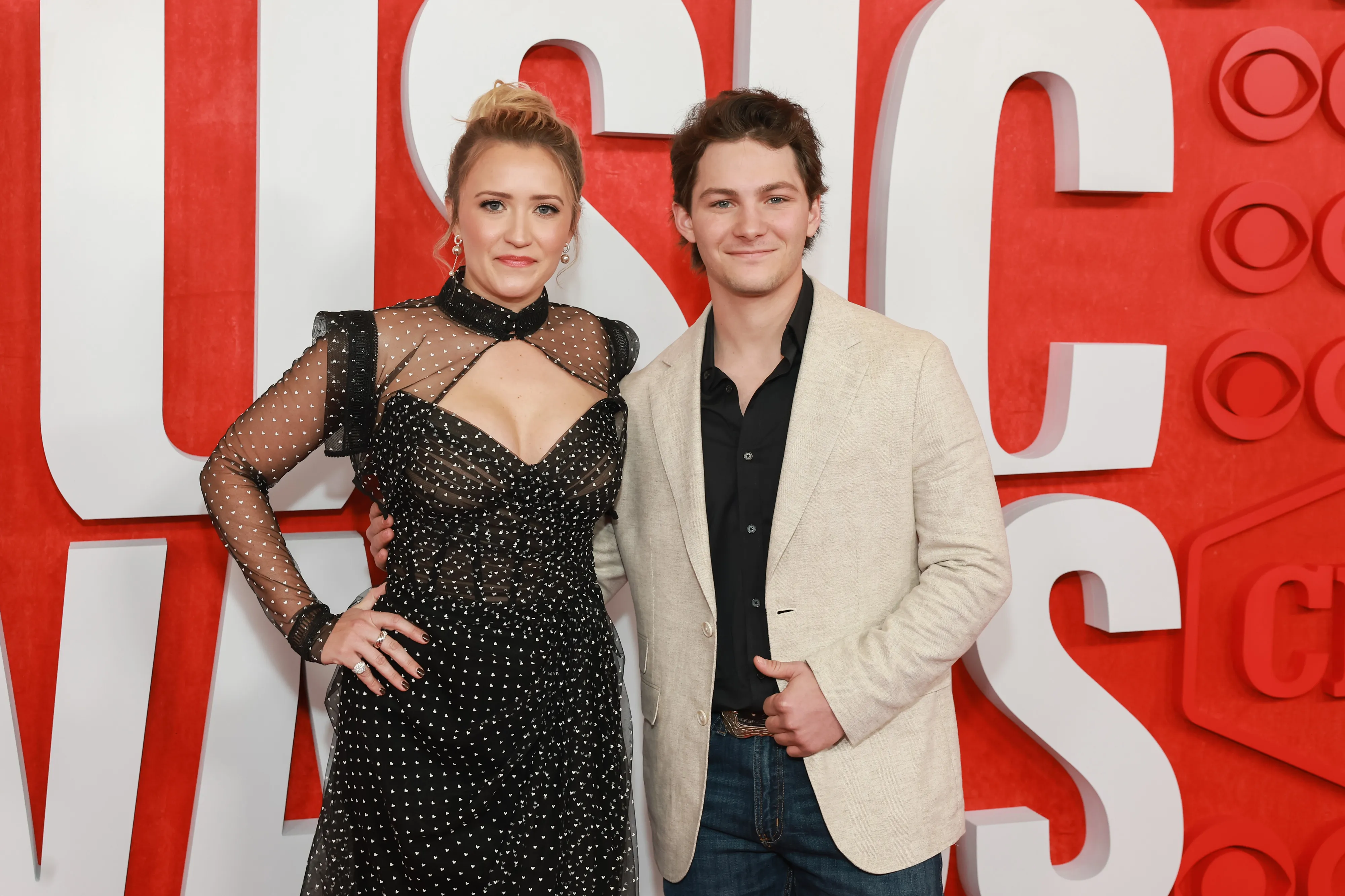 Emily Osment and Montana Jordan on the red carpet at the CMT Music Awards.