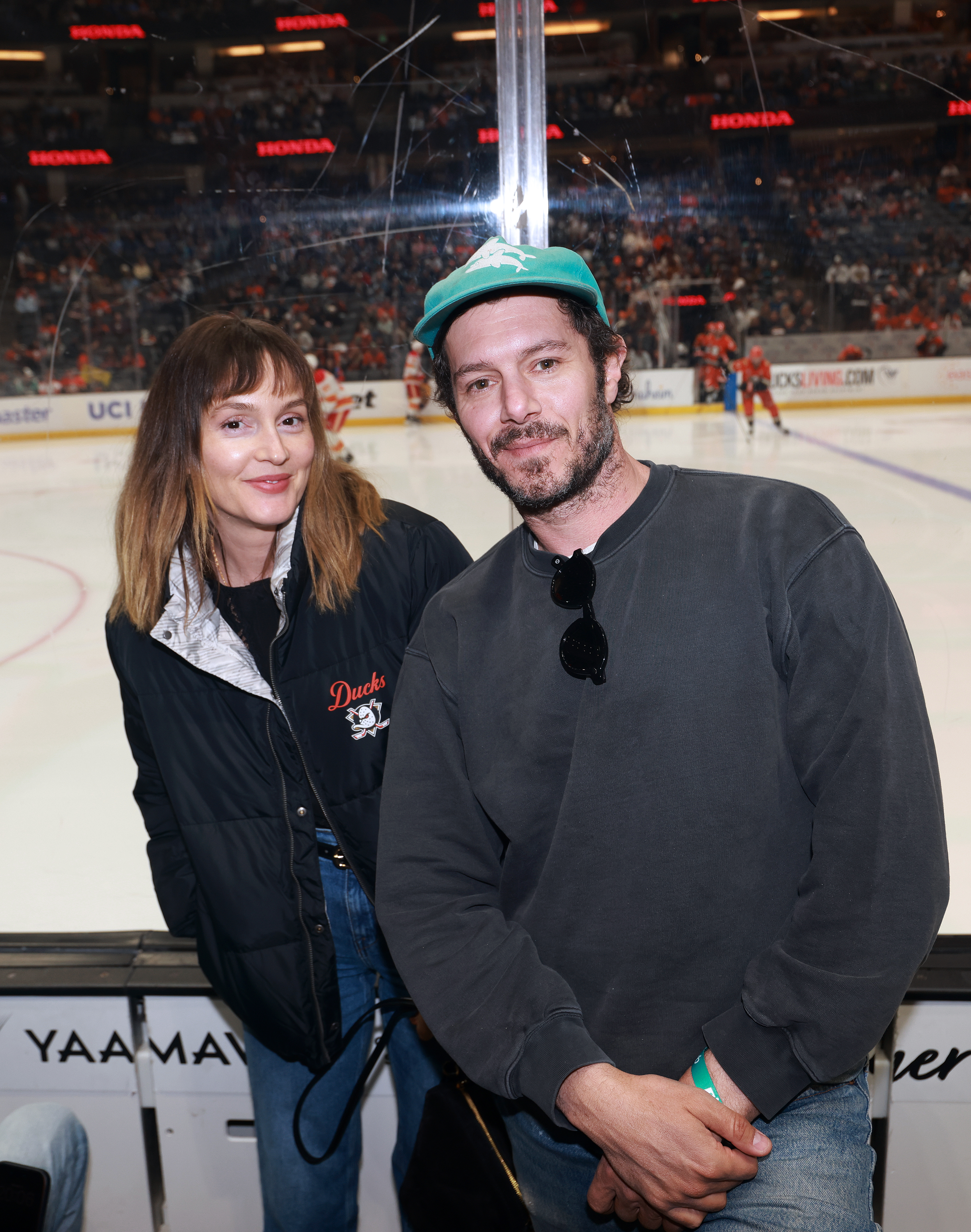 Leighton Meester and Adam Brody attend a hockey game.