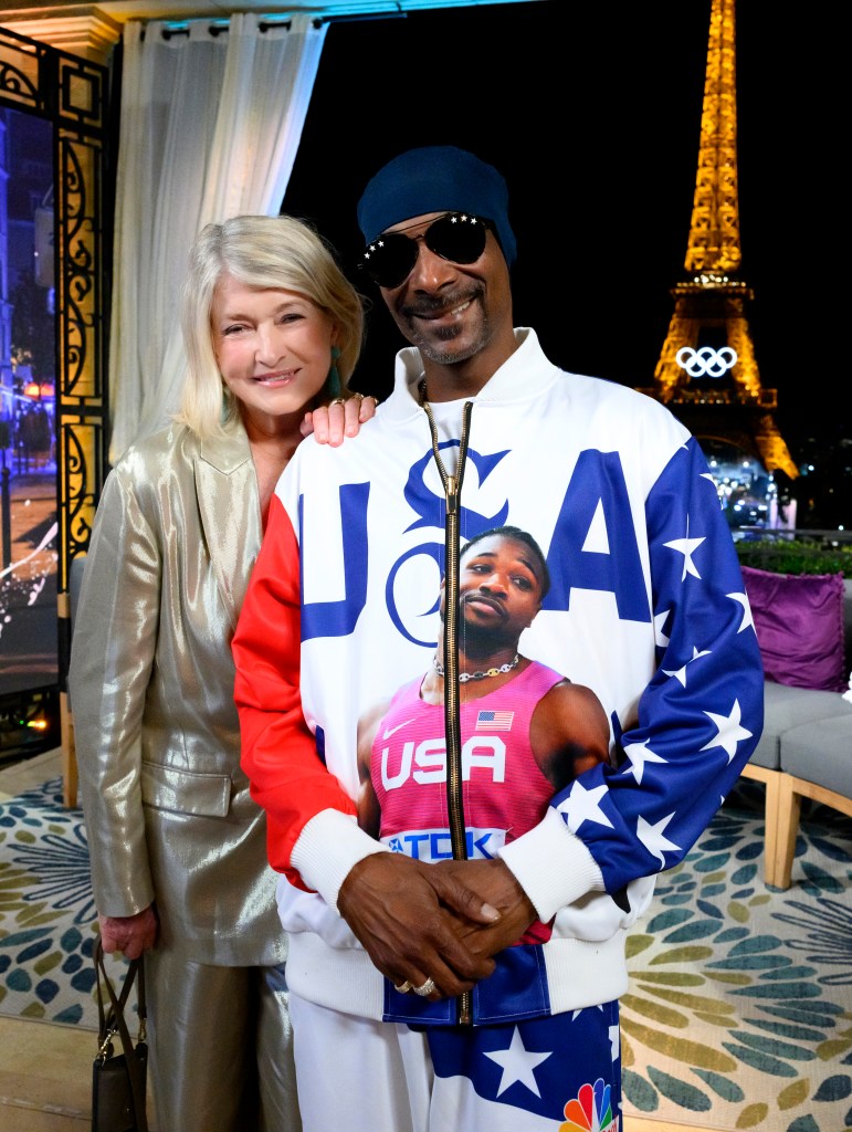 Martha Stewart and Snoop Dogg pose together on a set with the Eiffel Tower in the background.