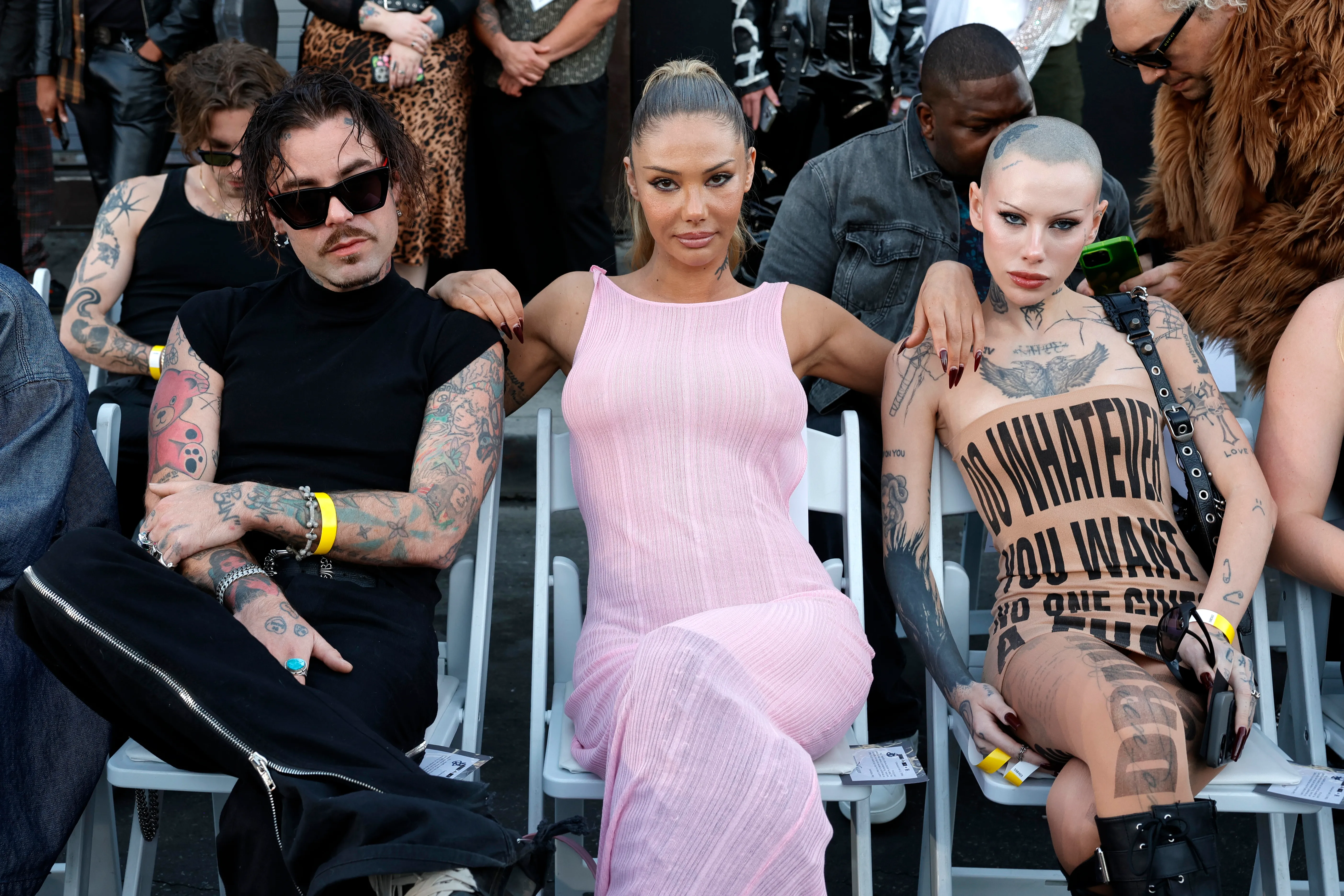 Mod Sun, Sahara Ray, and SIIICKBRAIN sitting together in the front row of a fashion show.