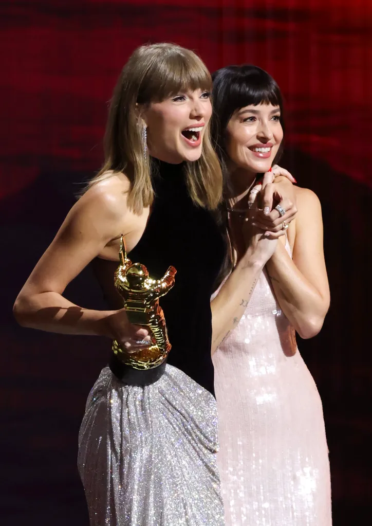 Taylor Swift accepts the Artist Director Honors from Dakota Johnson onstage at the MTV Video Music Awards.