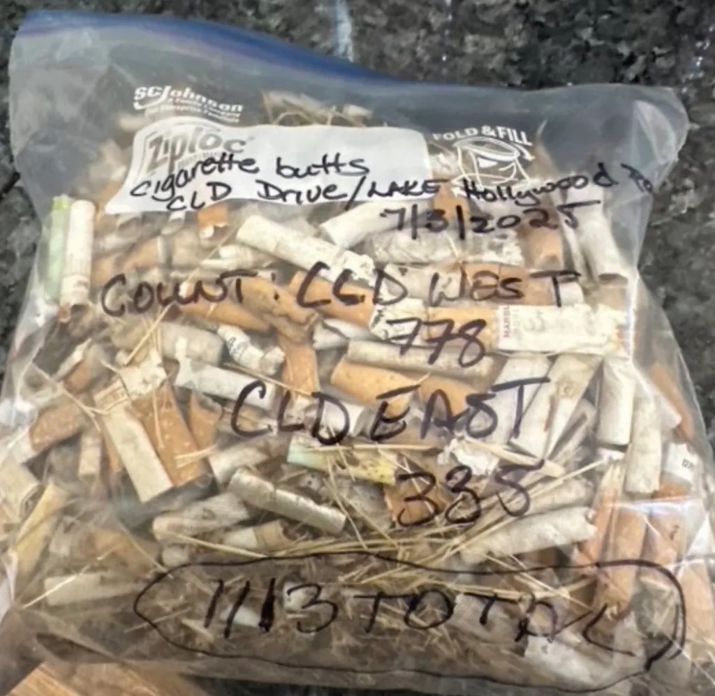 A plastic storage bag filled with discarded cigarette butts, with handwritten counts and locations marked on the outside.