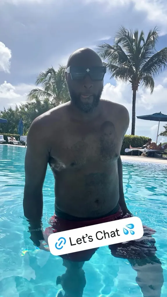 Lamar Odom standing in a swimming pool wearing sunglasses with a 