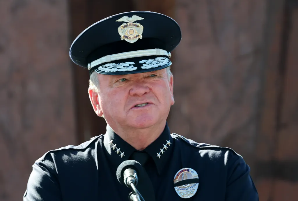 LAPD chief Jim McDonnell in uniform speaking into a microphone.
