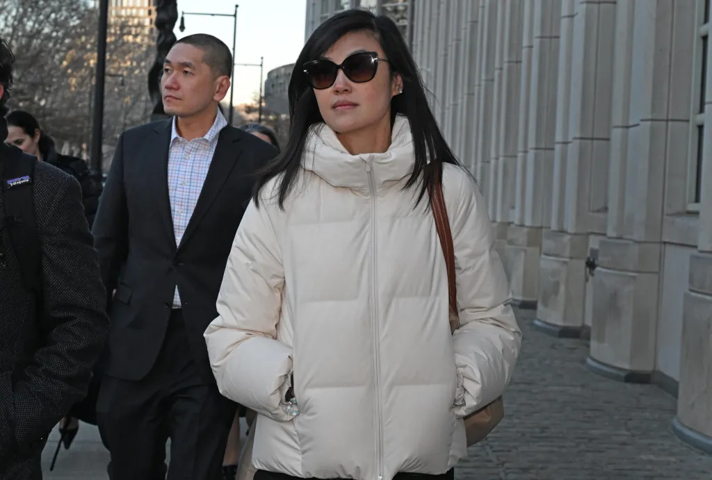 Linda Sun and her husband, Christopher Hu, leaving Brooklyn Federal Court.