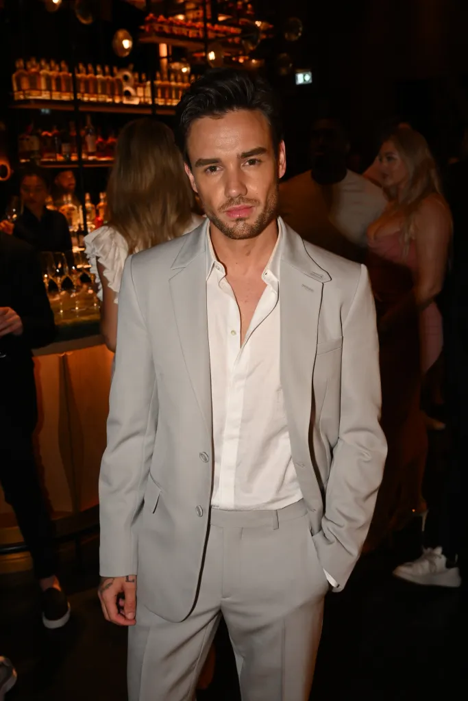 Liam Payne attends the opening of Nobu Dubai in a grey suit and white shirt.