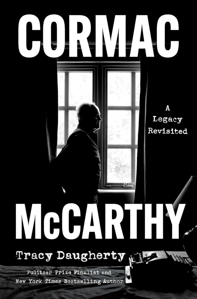 Book cover for Cormac McCarthy: A Legacy Revisited by Tracy Daugherty, featuring a black-and-white photo of Cormac McCarthy silhouetted against a window.