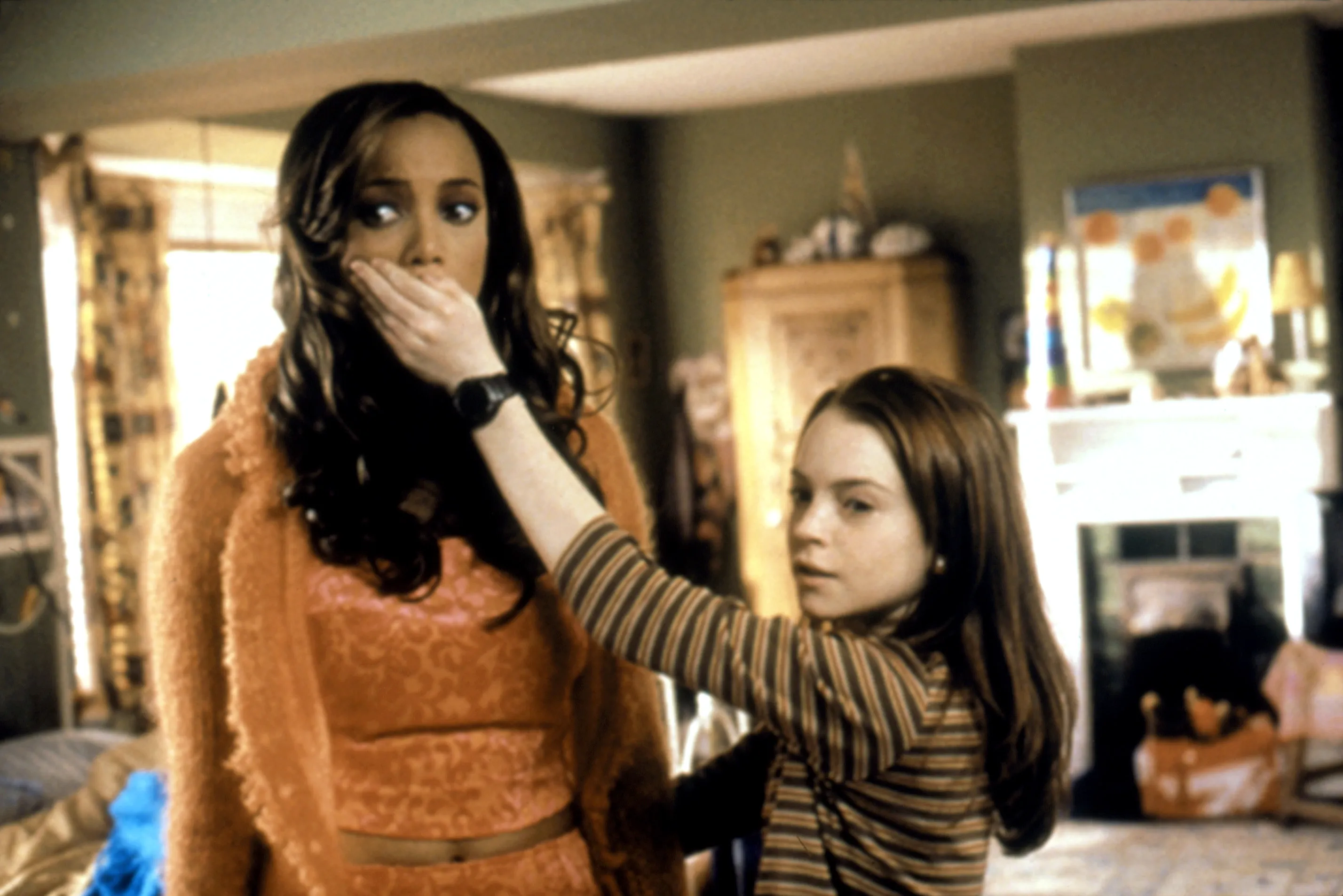 Tyra Banks with her hand covered by Lindsay Lohan in a scene from the movie Life-Size.