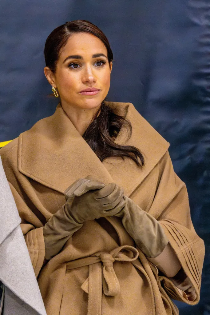 Meghan Markle wearing a tan coat and matching gloves.