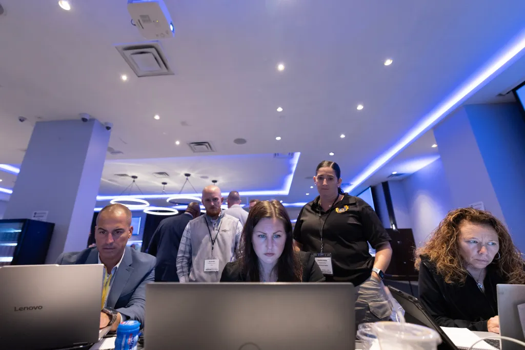 Professionals collaborate at computers during the Long Island Missing Child Rescue Operation.