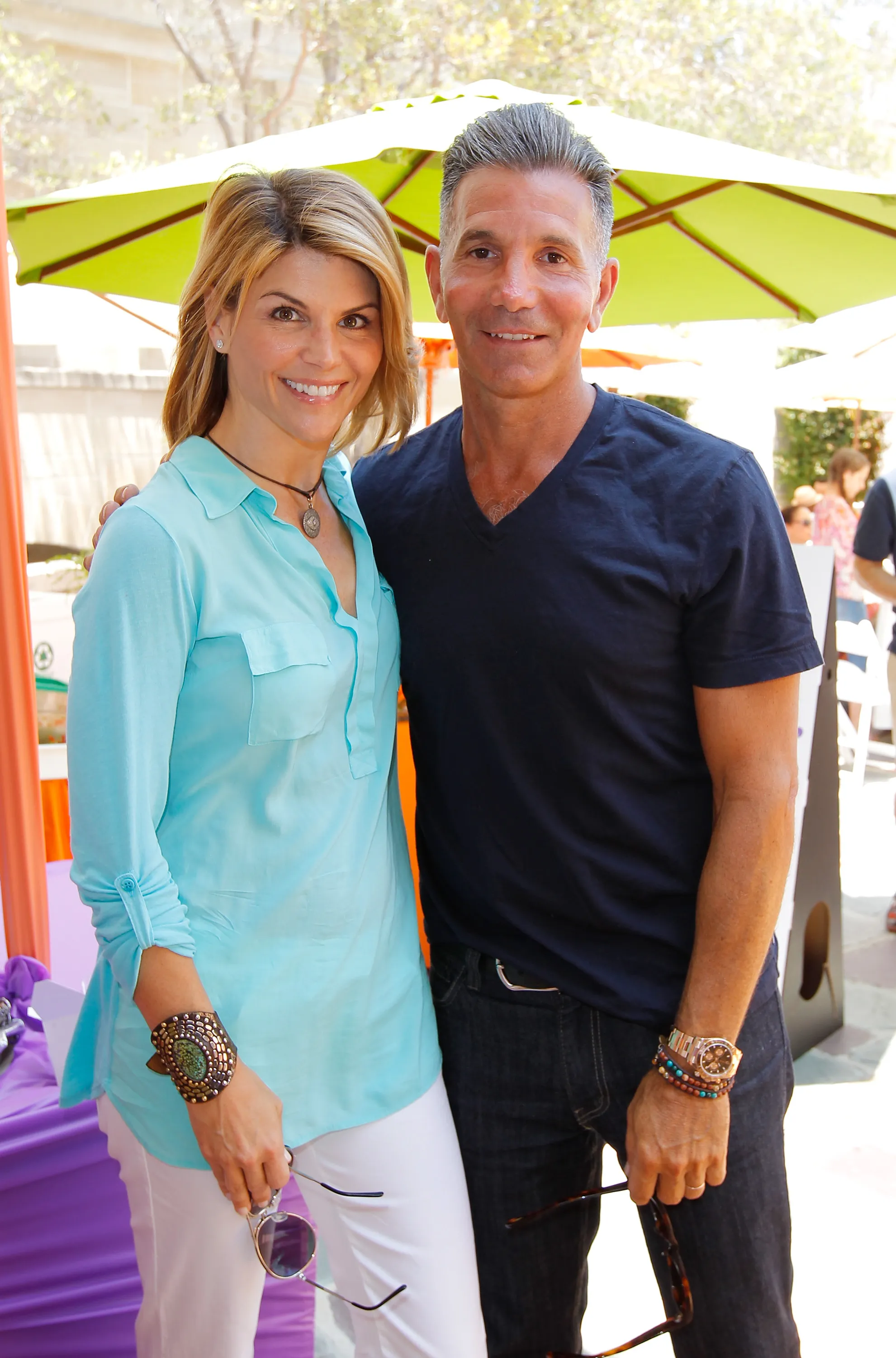 Lori Loughlin and Mossimo Giannulli posing together outdoors.