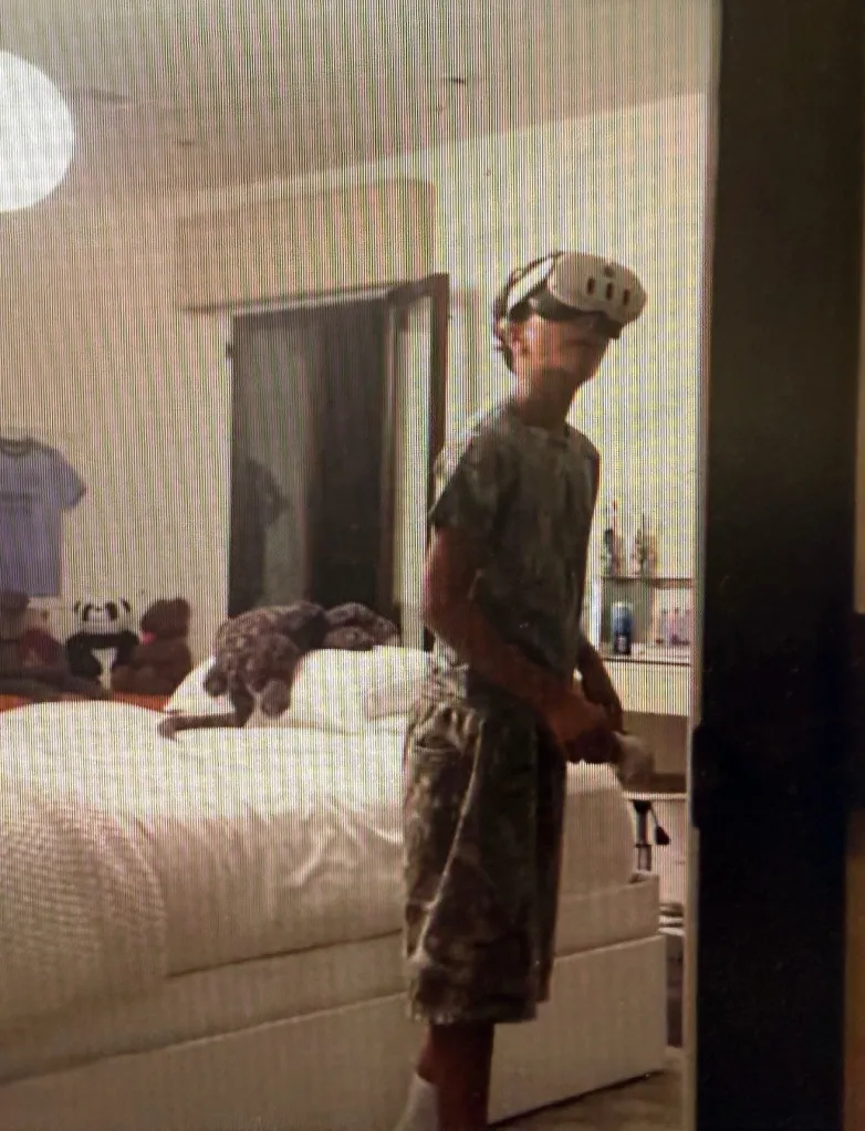 Halle Berry's son Maceo wearing a VR headset in a bedroom.