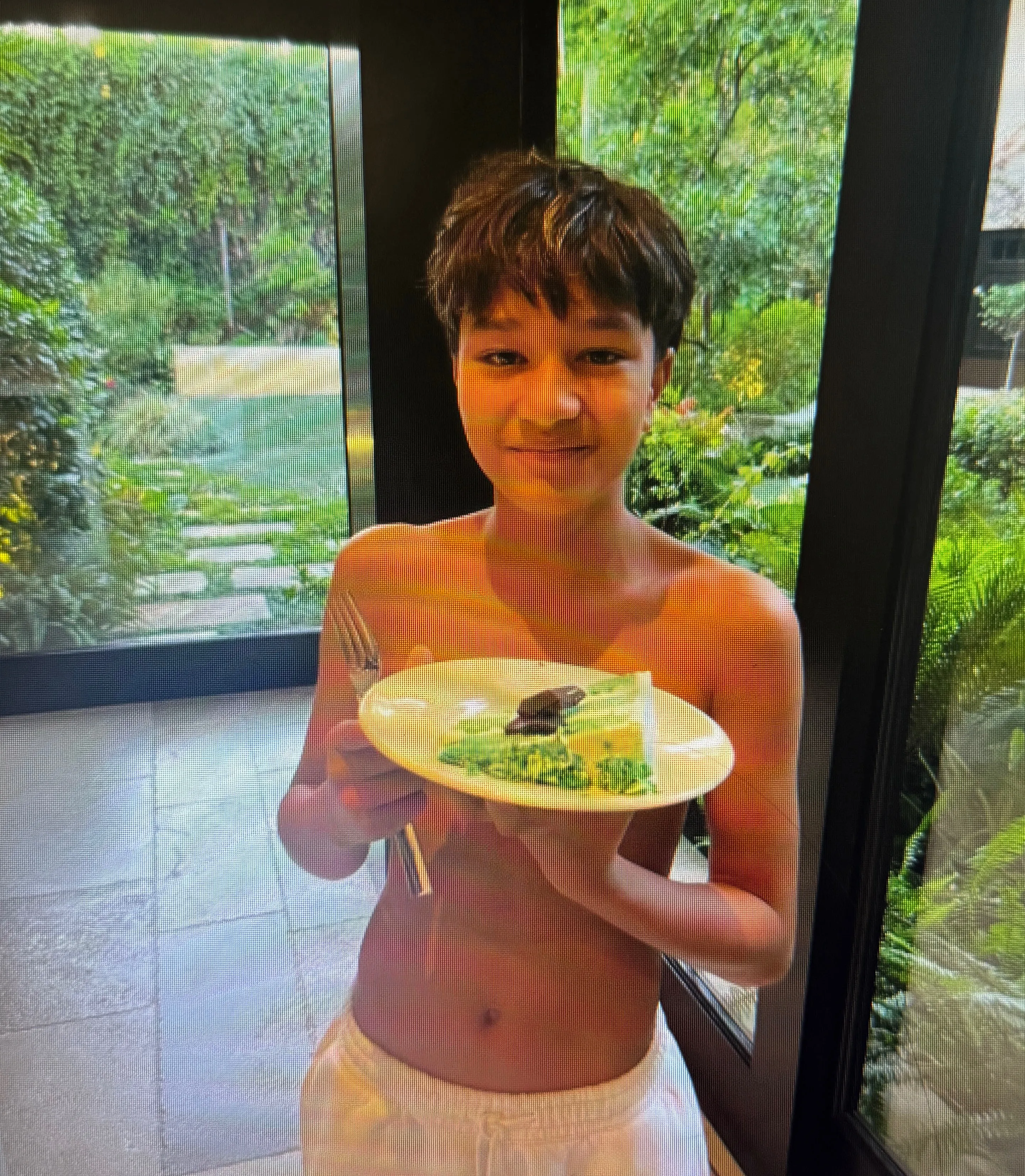 Halle Berry's son Maceo holding a plate of food in court documents.