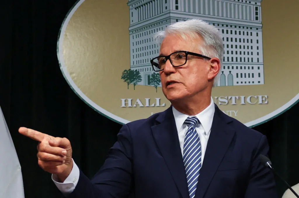 Los Angeles County District Attorney George Gascón speaks and points a finger during a news conference.