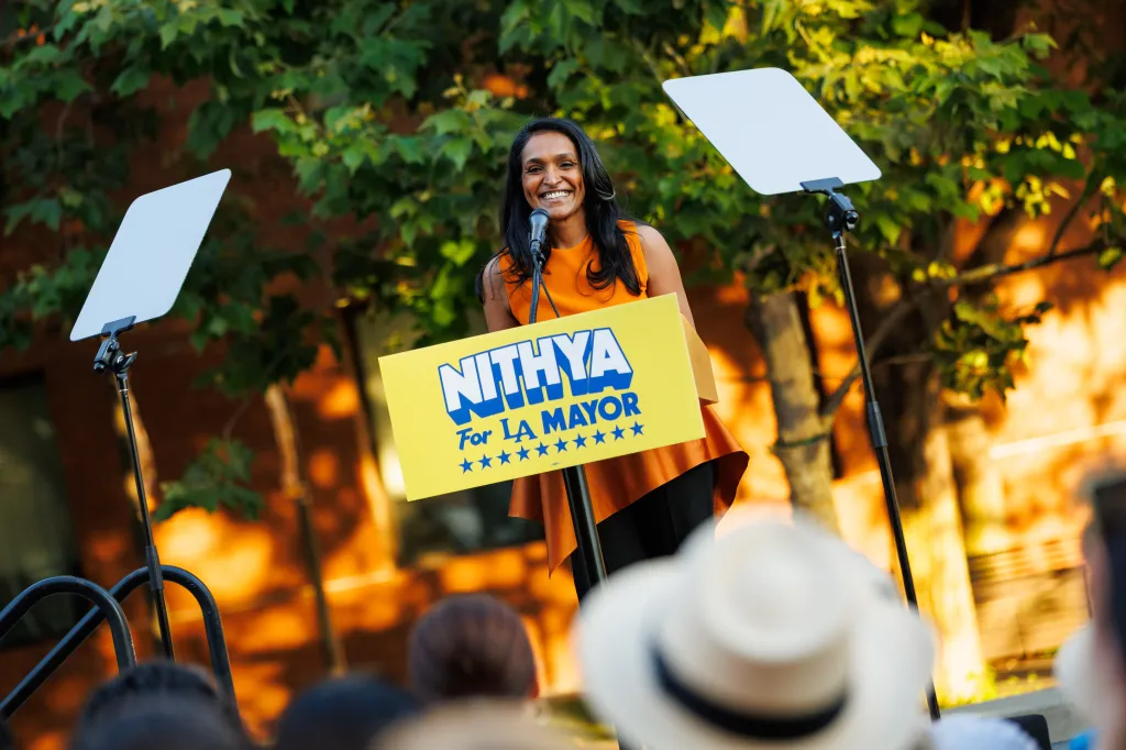 Los Angeles mayoral candidate Nithya Raman speaks to supporters at a campaign event, standing behind a podium that reads 
