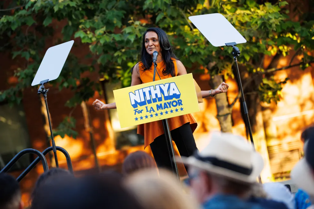 Los Angeles mayoral candidate Nithya Raman speaks to supporters at a campaign event, standing behind a podium that reads