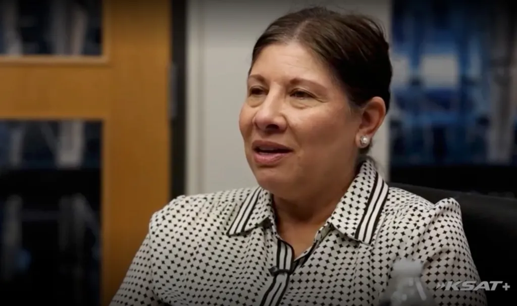Lucy Hernandez looking forward while wearing a patterned blouse.
