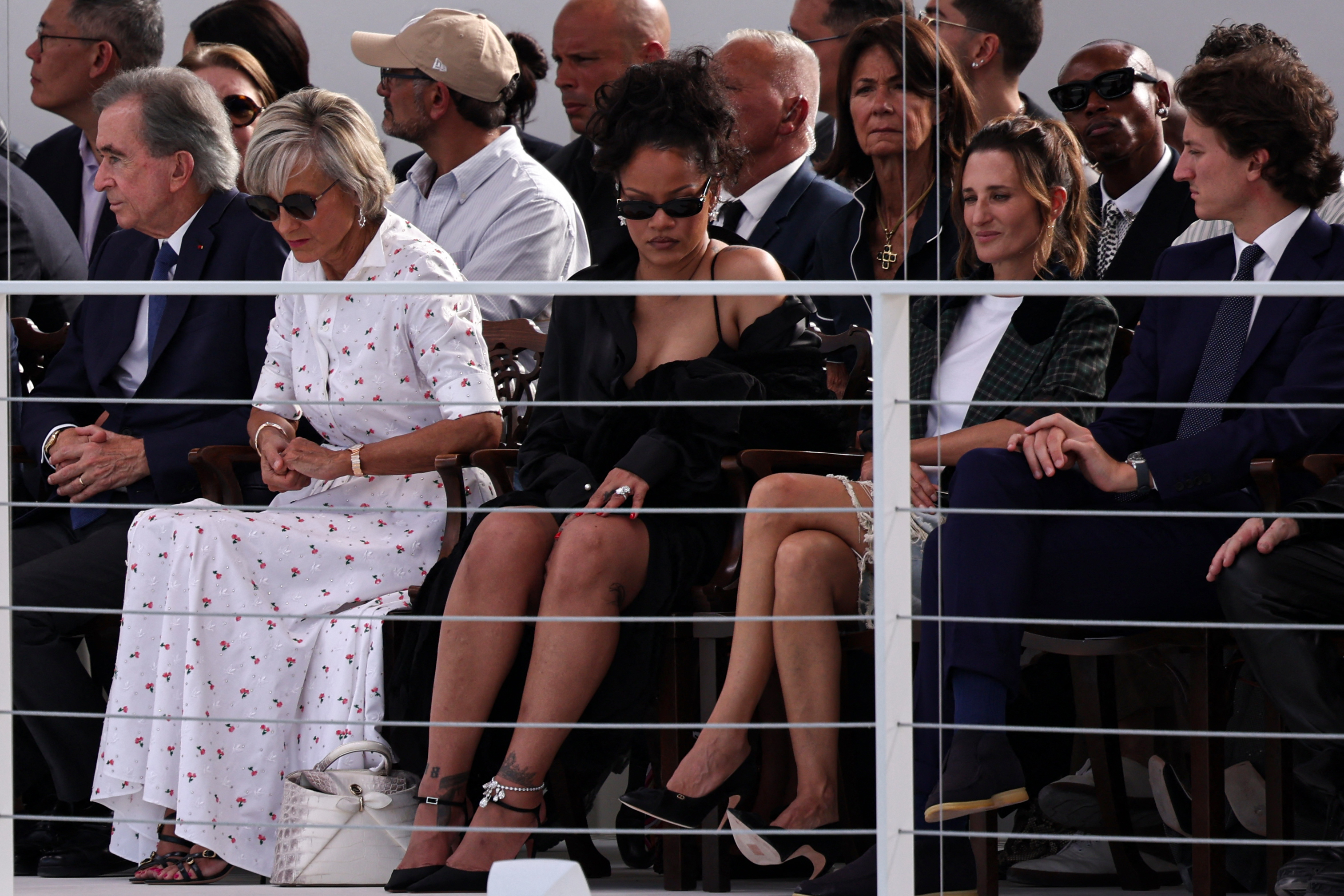 Bernard Arnault, Helene Mercier-Arnault, Rihanna, Camille Cottin, and Jean Arnault seated in the front row at a Christian Dior fashion show.