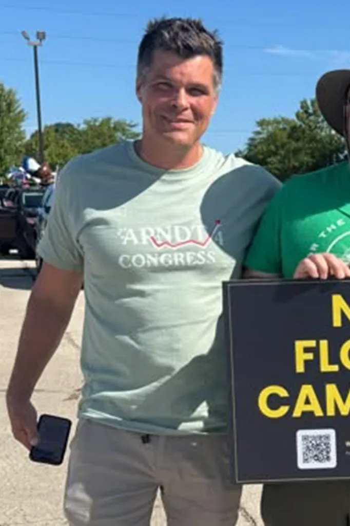 Matthew Arndt wearing a light green campaign t-shirt.