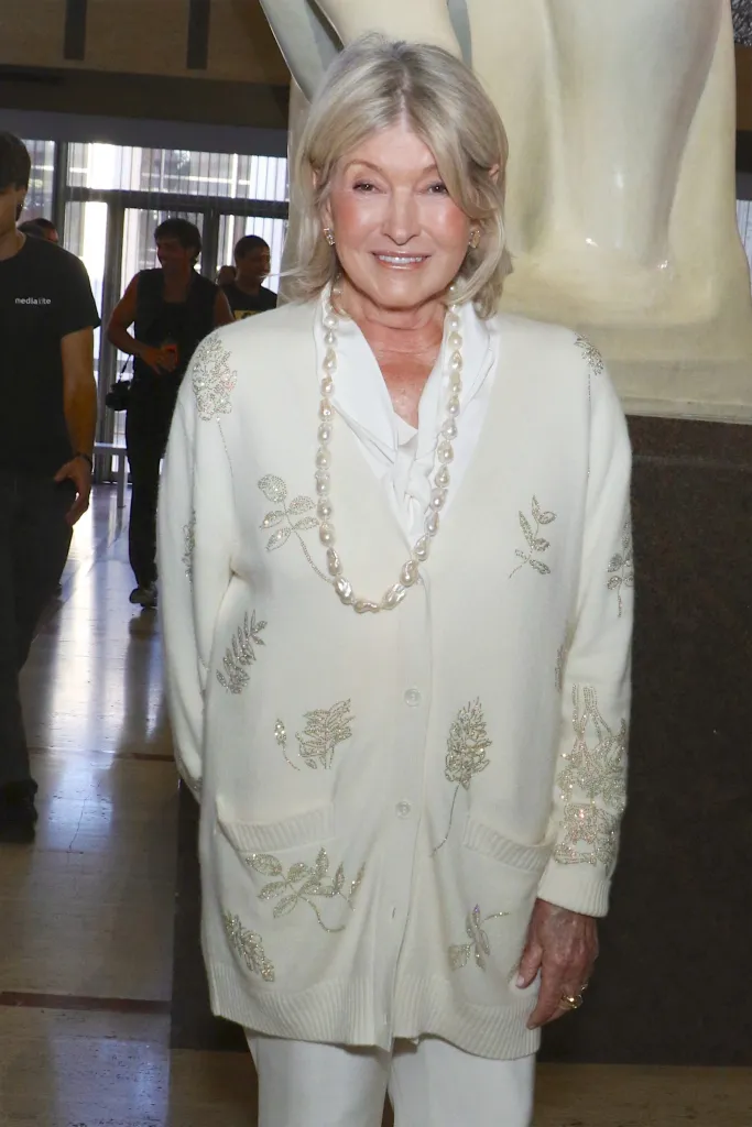 Martha Stewart wearing a white cardigan and a pearl necklace at New York Fashion Week.