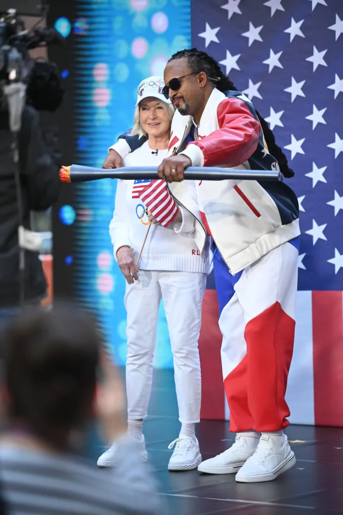 Martha Stewart and Craig Melvin dressed as Snoop Dogg and carrying an Olympic torch during the TODAY Halloween Extravaganza.