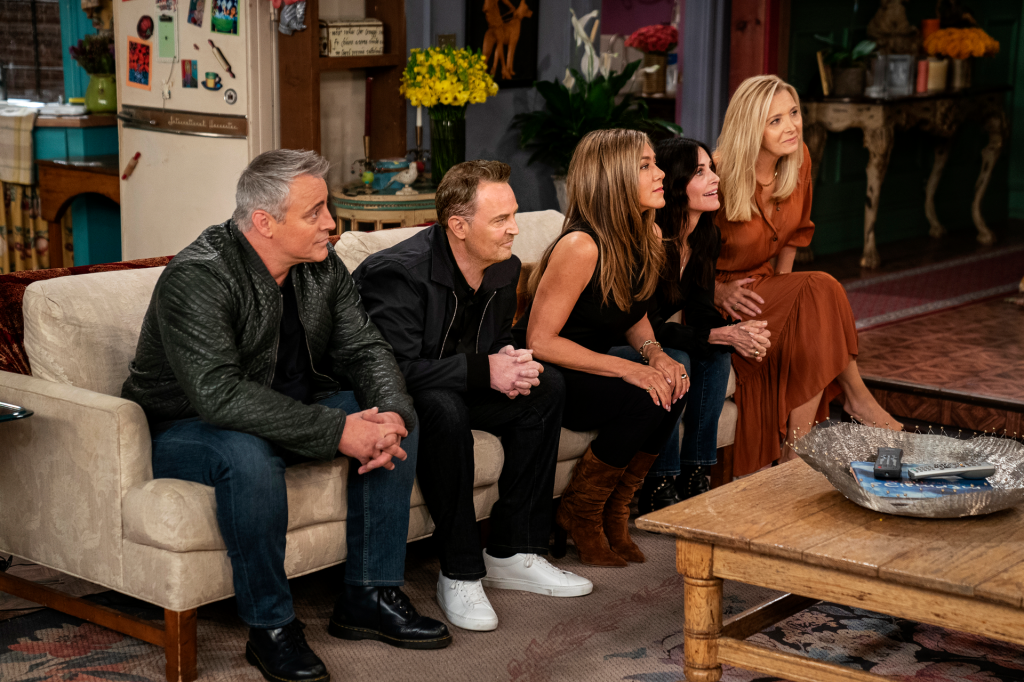 Matt LeBlanc, Matthew Perry, Jennifer Aniston, Courteney Cox, and Lisa Kudrow sitting on a sofa during Friends: The Reunion.