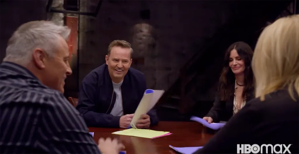 Matthew Perry and other cast members gathered around a table with scripts during the Friends reunion.