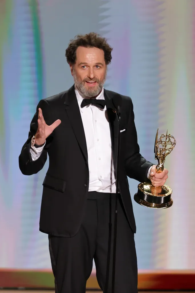 Matthew Rhys accepts an award onstage during the 78th Primetime Emmy Awards.