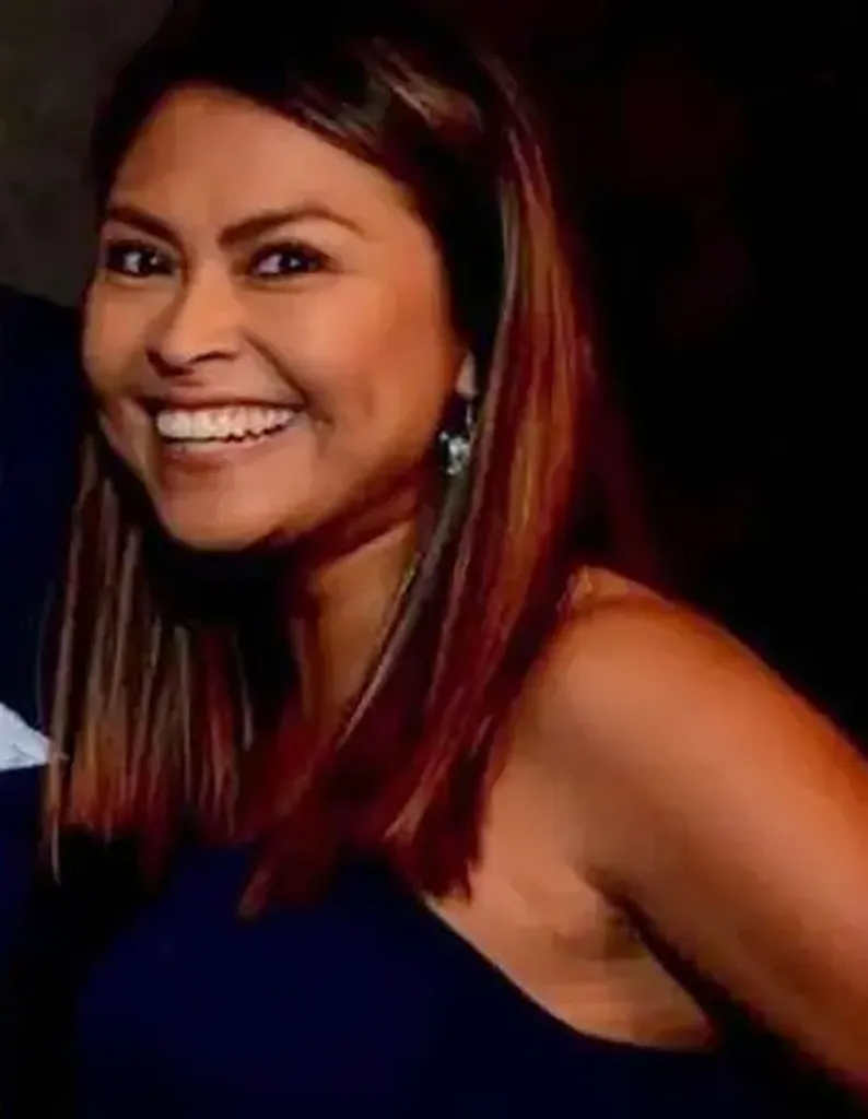 Mayra Jimenez smiling and wearing a dark top.