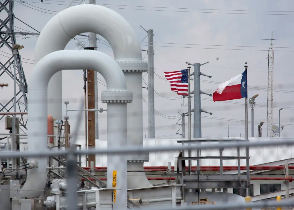 American and Texas flags flying behind crude oil pipes at the Strategic Petroleum Reserve in Freeport, Texas.