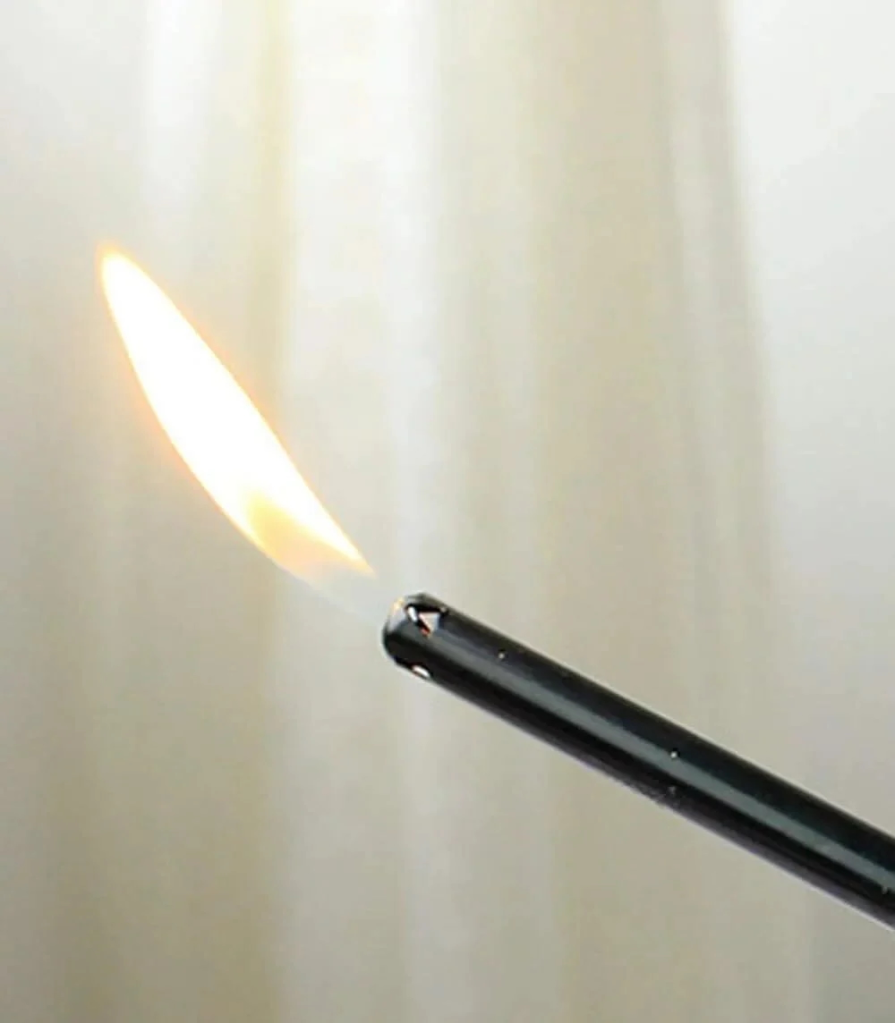 A Bic non-refillable straight stem utility butane lighter with an active flame.