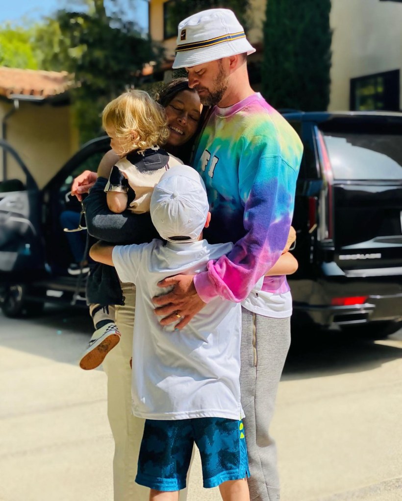 Justin Timberlake, Jessica Biel, and their kids, Silas and Phineas, embracing outdoors.