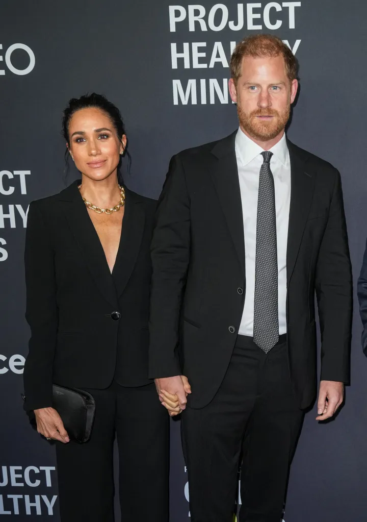 Meghan, Duchess of Sussex, and Prince Harry, Duke of Sussex, holding hands at the Project Healthy Minds Gala.