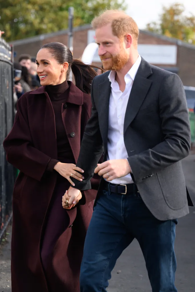 Meghan, Duchess of Sussex and Prince Harry, Duke of Sussex hold hands as they arrive in Nottingham.