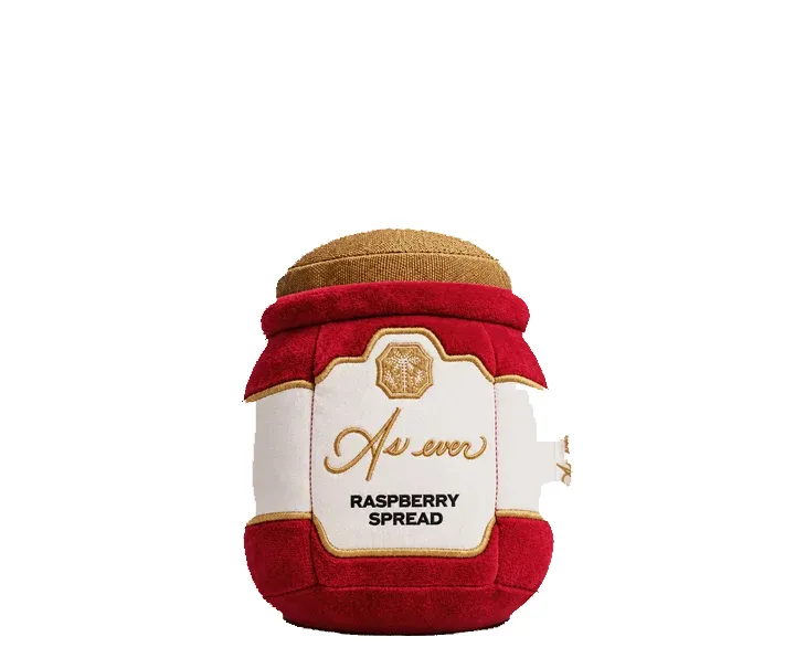 A plush jar of As Ever raspberry spread with a white label and gold lettering.